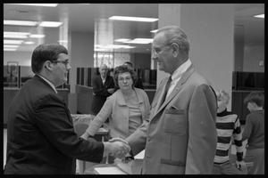 Primary view of object titled '[Lyndon B. Johnson shakes hands with reporter]'.