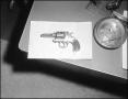 Photograph: [Jesse James' Pistol Staged on Sheriffs Desk]