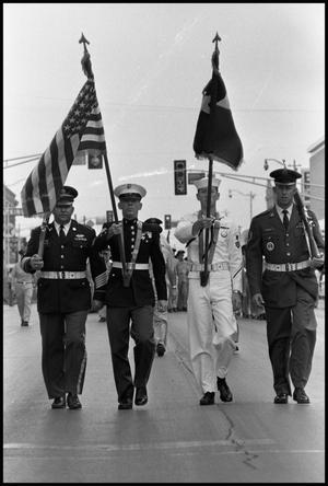 [Uniformed Men Carrying Flags in Armed Forces Day Parade]