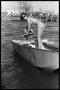 Photograph: [Woman Fiddles With Boat Motor]