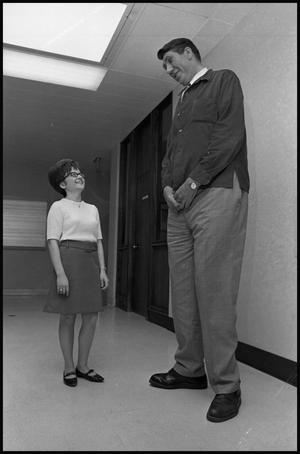 Primary view of object titled '[7' 8" Man With Small Woman]'.