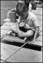 Photograph: [Boy on Wooden Fishing Pier]
