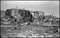 Photograph: [Men Walk Among Destroyed Homes From Tornado]