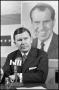 Photograph: [John Tower Sits in Front of Richard Nixon Poster]