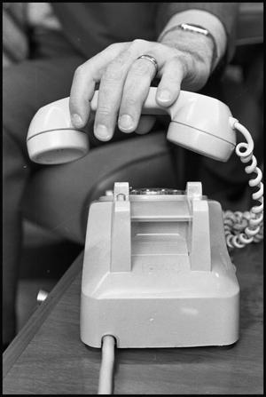 [Dr. Don Waldrip's Hand Lifting Telephone Receiver]