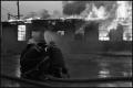 Photograph: [Three Firefighters Fight Blaze]