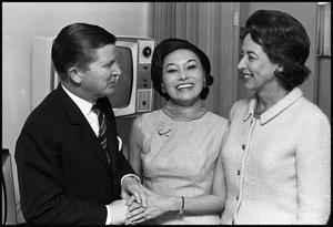 [John Tower and Wife Greet Smiling Woman]