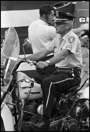 [Motorcycle Cop Riding in Armed Forces Day Parade]