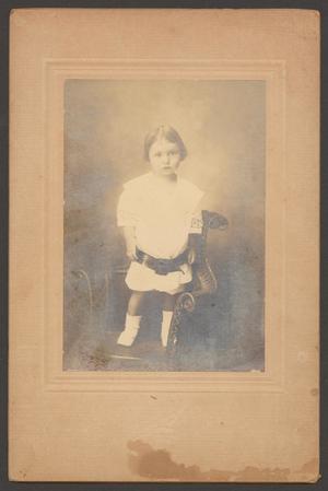 [Photograph of a Small Child Standing on a Chair]