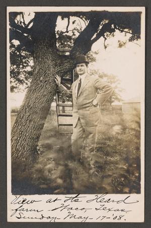 [Postcard of a Man Standing Next to a Tree]