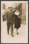 Photograph: [Photograph of One Woman and One Man on a Street]