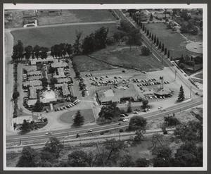 [Aerial view of apartments and building with tower]