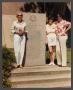 Photograph: [Gayle Snell and two women standing next to WASP monument]