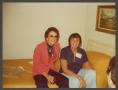 Photograph: [Gayle Snell with Friend on Bed]