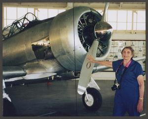 [Gayle Snell posing with T-6]