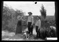 Photograph: [Three People with Dog]