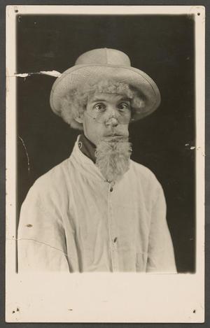 [Photo of a Man Wearing a Fake Beard and Hat]
