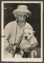 Photograph: [Photo of a Man Holding a Dog]