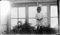 Photograph: [Child Standing in Front of Windows]