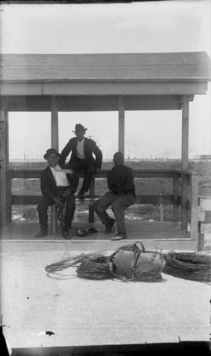 [Three Men Posing on a Bench]