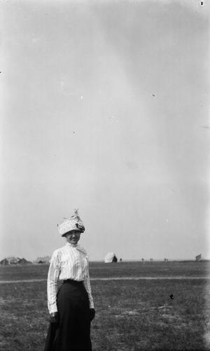 [Woman in a Hat Stands in a Field]