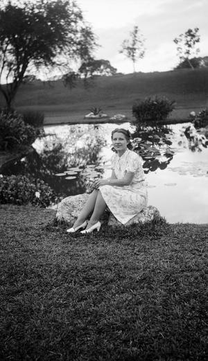 [Woman Sitting by a Pond]