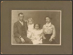 [Photograph of a Man, Two Girls, and a Woman]