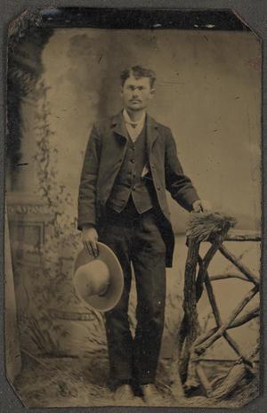 [Photograph of a Man Next to a Rustic Table]