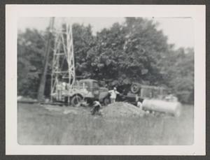 [Workers Near Derrick and Equipment]