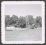 Photograph: [Derrick and Tank in Field]