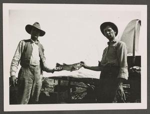 Primary view of object titled '[Two Men Pose with a Fish]'.