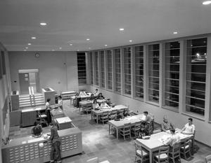 Primary view of object titled 'Library interior with students'.