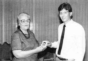 Billie Carr, left, of the National Democratic Committee,  accepts a gift from Mitch Jackson of the young democrats at Lee College