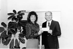 [Linda Hischke Presenting a Check to John Tucker]