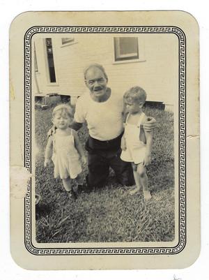 Primary view of object titled '[Photograph of a Man Posing with Two Children]'.