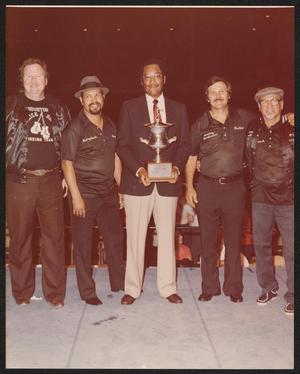 Primary view of object titled '[Lee Brown Holding a Trophy with Four People]'.