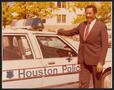 Photograph: [Lee Brown Standing Next to a Police Car]