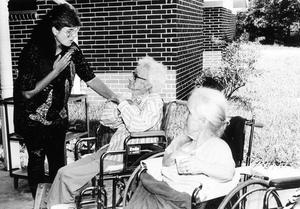 Instructor Cindy Barny chats with nursing home residents who participate in weekly activities classes.