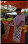 Thumbnail image of item number 1 in: '[Individuals at food booth at PACfest]'.