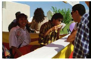 Primary view of object titled '[Individuals at food booth at PACfest]'.