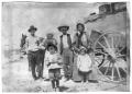 Photograph: People standing in front of wagon with household items, 1900