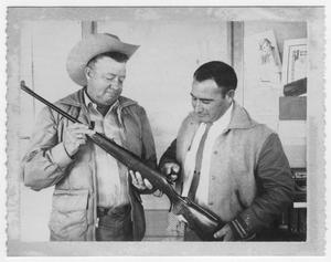 Tolbert Bell and H.O. "Hock" Haynes with rifle