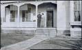 Photograph: [Man and two women on a porch]