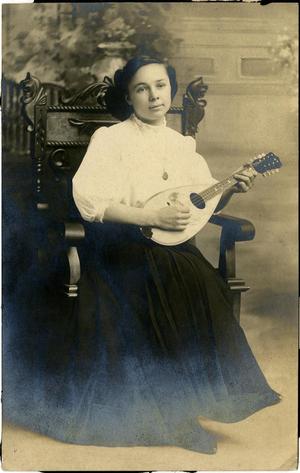 [Photograph of Nora playing a mandolin:  Postcard addressed to T. N. Carswell]