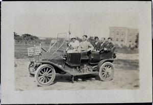 [Group of seven people in a motor car on Simmons College campus]