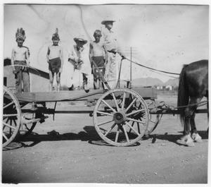 Allen Hall on wagon with children dressed as Indians