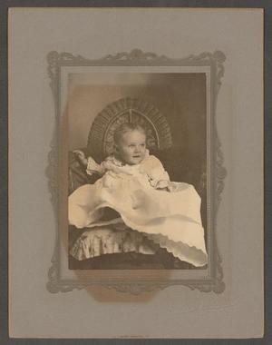[Unknown Child in a Wicker Chair with a Pillow]