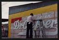 Thumbnail image of item number 1 in: '[Photograph of C.B. Morgan Restoring Dr. Pepper Mural]'.