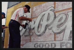 Primary view of object titled '[Close-Up of Artists Restoring Dr. Pepper Mural]'.