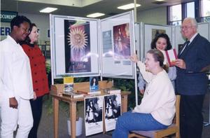 Lee College students join Dr. Kenneth Roach, head librarian, to visit a photo panel exhibit "The Sun Ling, Louis XIV and the new world".From left, Vallerie Lane, Jeri Donahue, Brandi Lanphier, seated in forefront, Allison Berg
